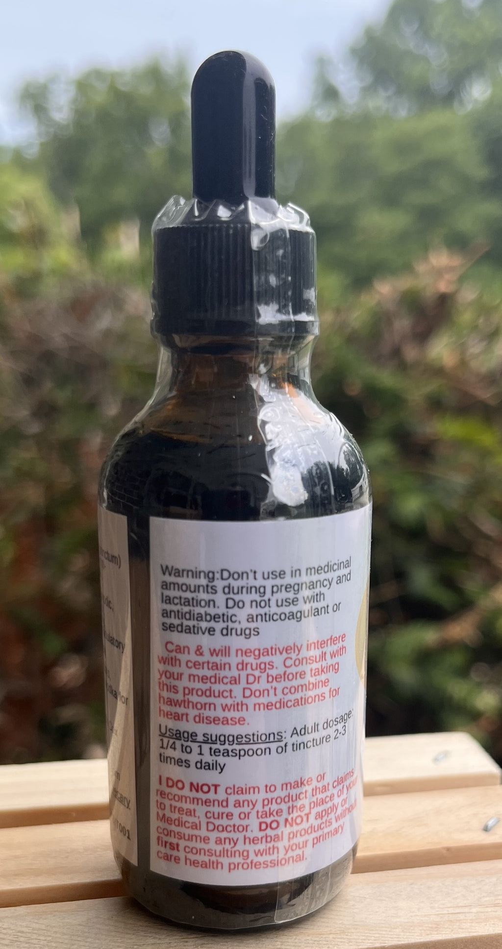 Back of Tulsi tincture bottle showing the warning and usage label